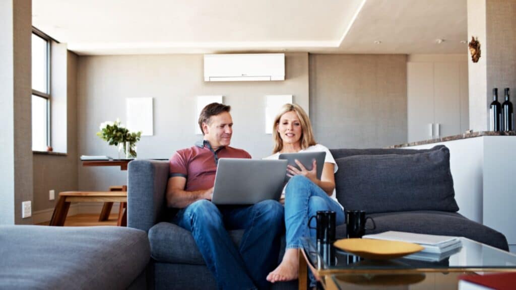 Married couple in living room - Heating House with Mini Split.